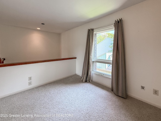 515 N Putnam St Unit B, Williamston, MI 48895 - spare room with light carpet, baseboards, and recessed lighting