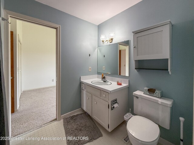 515 N Putnam St Unit B, Williamston, MI 48895 - bathroom with vanity, toilet, baseboards, and tile patterned flooring