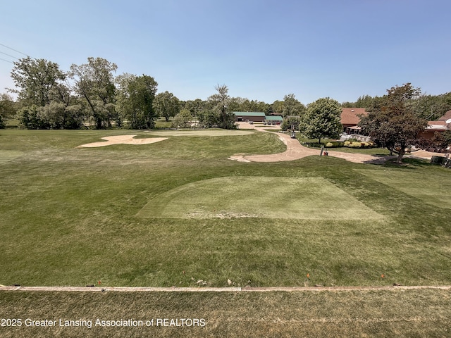 515 N Putnam St Unit B, Williamston, MI 48895 - view of community with a lawn, view of wooded area, and view of golf course