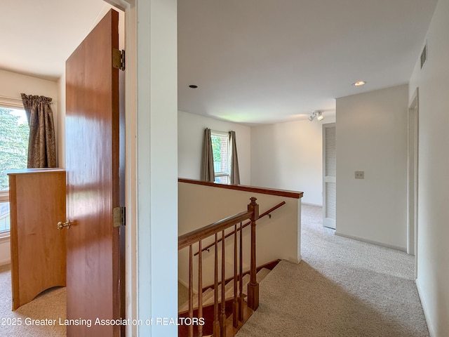 515 N Putnam St Unit B, Williamston, MI 48895 - hall featuring an upstairs landing, carpet, and recessed lighting
