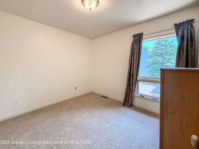 515 N Putnam St Unit B, Williamston, MI 48895 - carpeted empty room with baseboards