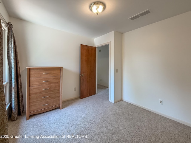 515 N Putnam St Unit B, Williamston, MI 48895 - carpeted bedroom featuring baseboards