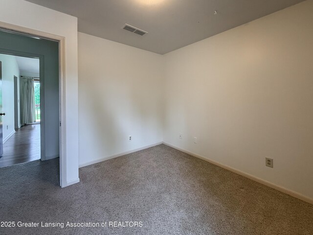 515 N Putnam St Unit B, Williamston, MI 48895 - carpeted empty room featuring baseboards