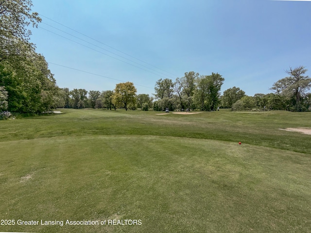 515 N Putnam St Unit B, Williamston, MI 48895 - view of home's community featuring view of wooded area, a yard, and view of golf course