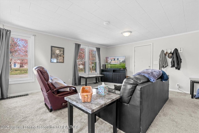 living area with light colored carpet, ornamental molding, and a healthy amount of sunlight
