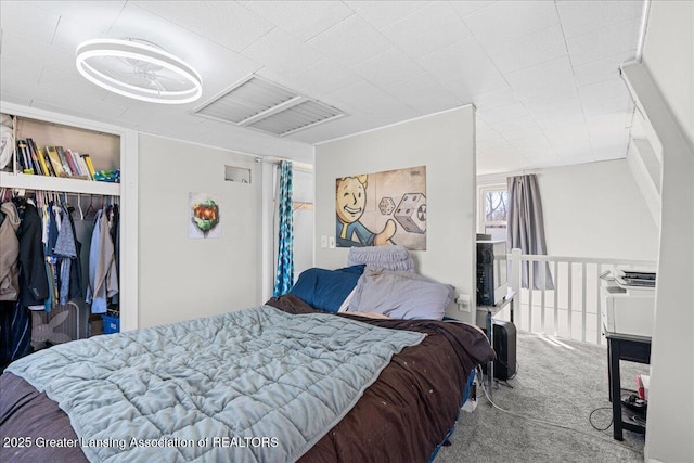 carpeted bedroom featuring visible vents and a closet