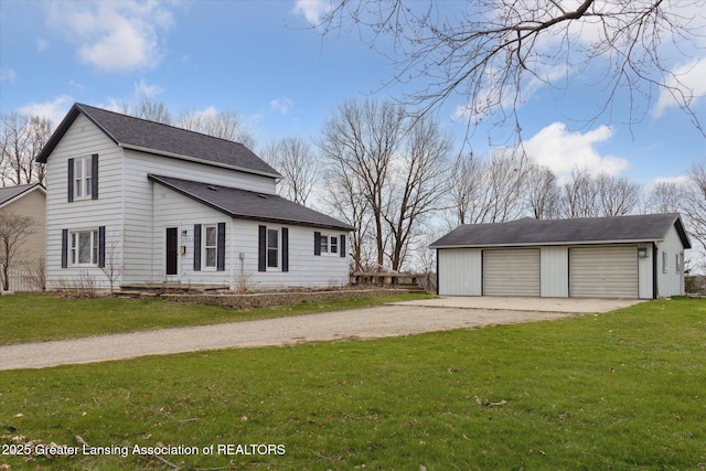 view of front facade with gravel driveway, a front lawn, an outdoor structure, and a garage