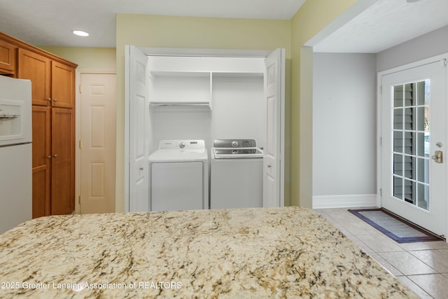 4163 Hamlet Cv, Bath, MI 48808 - laundry room with separate washer and dryer, laundry area, tile patterned floors, baseboards, and recessed lighting