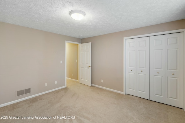 4163 Hamlet Cv, Bath, MI 48808 - unfurnished bedroom featuring a closet, a textured ceiling, carpet, visible vents, and baseboards