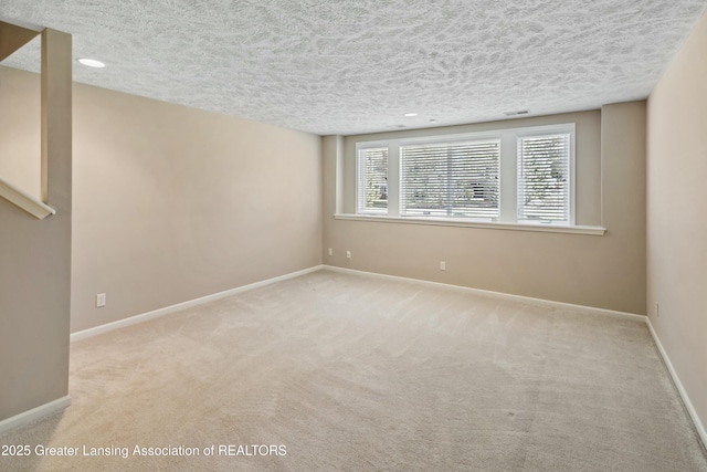 4163 Hamlet Cv, Bath, MI 48808 - spare room with baseboards, carpet flooring, visible vents, and a textured ceiling
