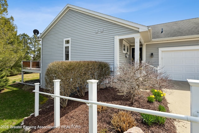 4163 Hamlet Cv, Bath, MI 48808 - view of property exterior featuring an attached garage, a shingled roof, and a yard