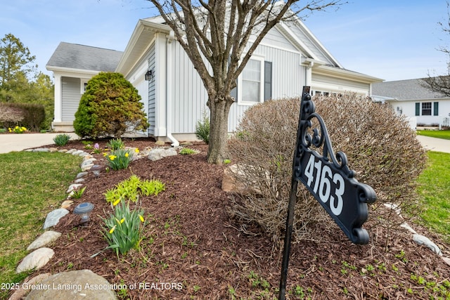 4163 Hamlet Cv, Bath, MI 48808 - view of side of property featuring board and batten siding and a garage