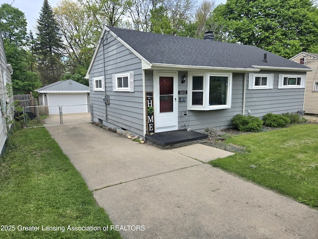 2032 Hillcrest St, Lansing, MI 48910 - view of front of property with a garage, a gate, an outdoor structure, a chimney, and a shingled roof