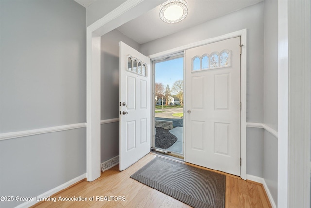 entryway with light wood-style floors and baseboards