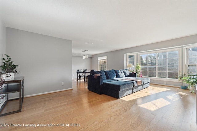 living area featuring light wood-type flooring and baseboards
