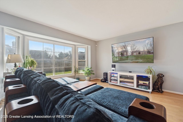 living area with wood finished floors and baseboards