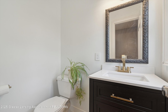 bathroom featuring toilet and vanity