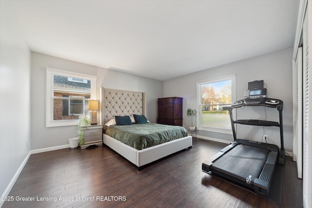 bedroom with wood finished floors and baseboards