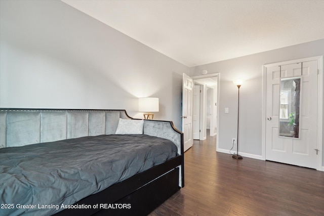 bedroom with baseboards and wood finished floors