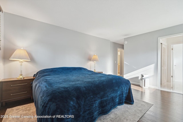 bedroom featuring wood finished floors and baseboards