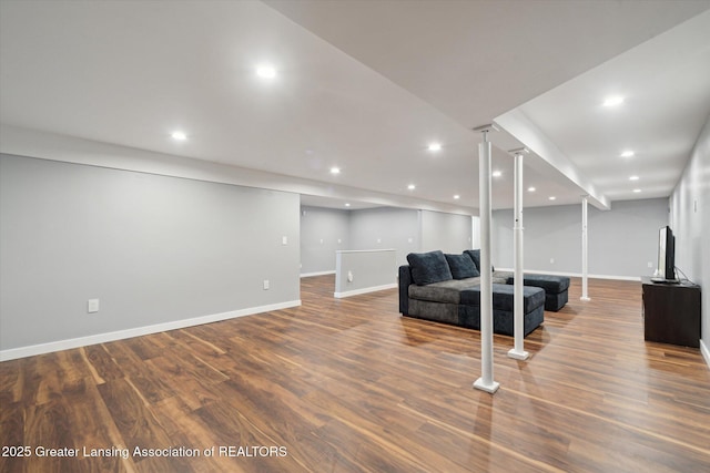 living area with baseboards, wood finished floors, and recessed lighting