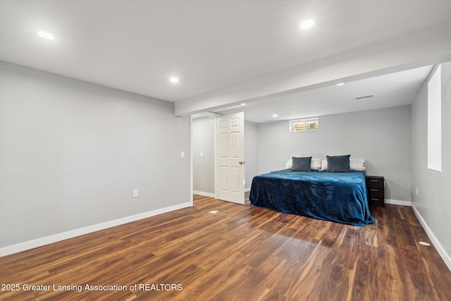 bedroom featuring visible vents, baseboards, wood finished floors, and recessed lighting