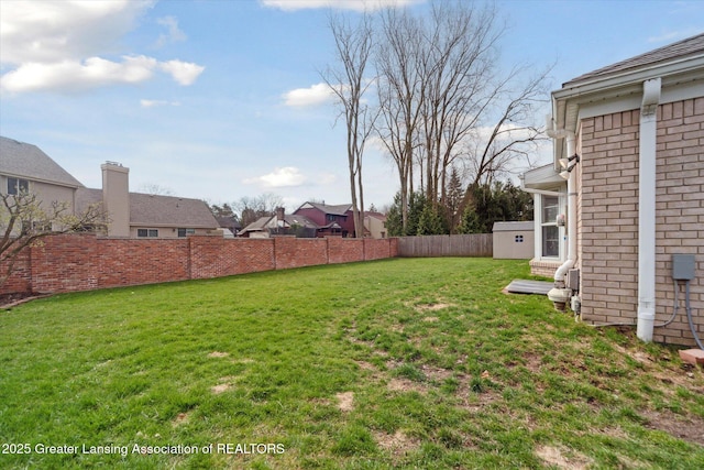view of yard with a fenced backyard and a residential view