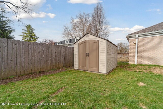 view of shed with a fenced backyard