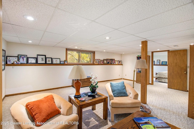carpeted living room featuring baseboards, a paneled ceiling, and recessed lighting