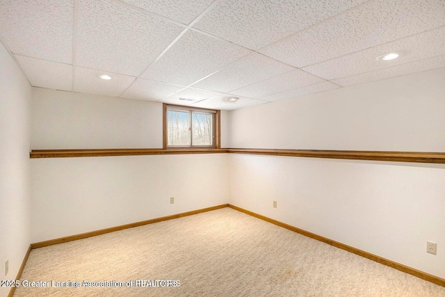 below grade area with recessed lighting, carpet, a drop ceiling, and baseboards