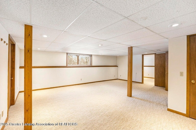 basement with recessed lighting, a paneled ceiling, carpet flooring, and baseboards