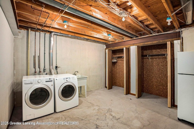 laundry room featuring laundry area, a sink, and washer and clothes dryer