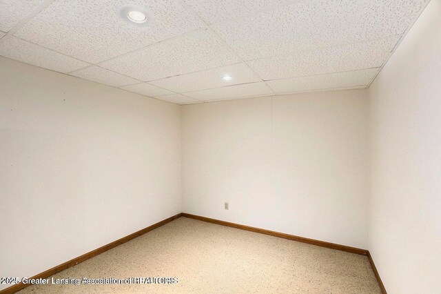 spare room with light carpet, a paneled ceiling, baseboards, and recessed lighting