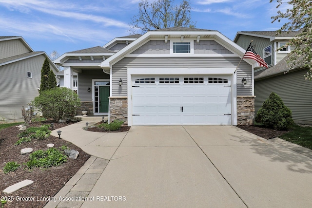 craftsman house with a garage, driveway, and stone siding