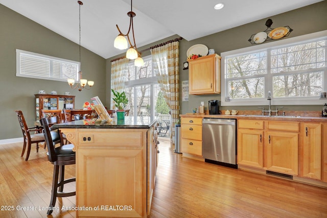 kitchen featuring visible vents, light brown cabinetry, light wood-type flooring, dishwasher, and a sink