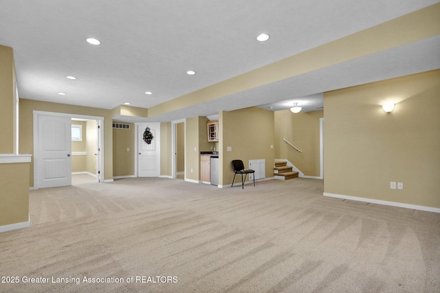 interior space featuring recessed lighting, baseboards, and light colored carpet