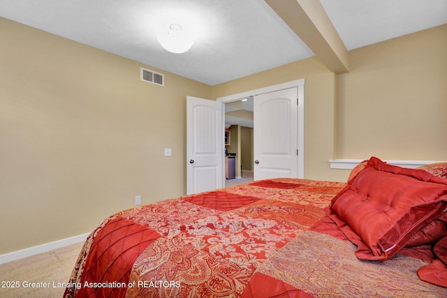 bedroom with carpet floors, baseboards, and visible vents