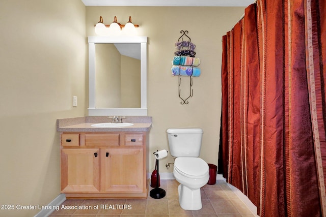 full bath with tile patterned floors, baseboards, vanity, and toilet