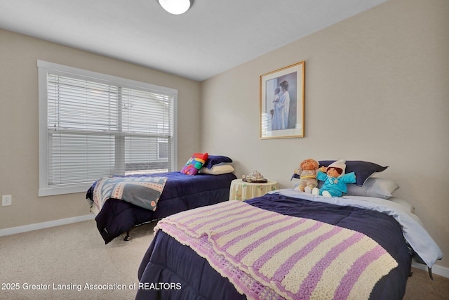 carpeted bedroom featuring baseboards