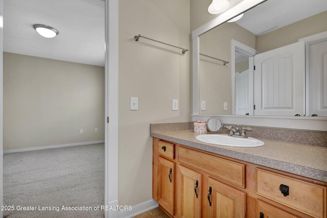bathroom with baseboards and vanity