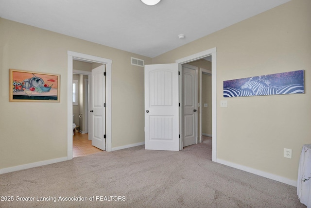 unfurnished bedroom with visible vents, connected bathroom, carpet, and baseboards