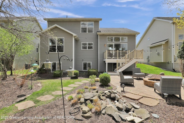 back of house featuring a patio, stairs, an outdoor fire pit, and a deck