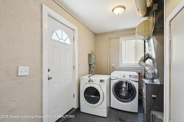 clothes washing area with separate washer and dryer and laundry area