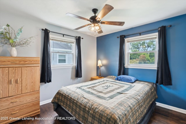 3427 W Jolly Rd, Lansing, MI 48911 - bedroom with multiple windows, dark wood-style flooring, and ceiling fan