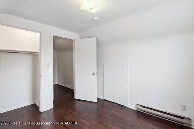 3427 W Jolly Rd, Lansing, MI 48911 - unfurnished bedroom featuring a baseboard radiator, wood finished floors, lofted ceiling, and a closet