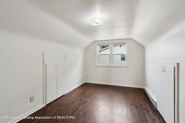 3427 W Jolly Rd, Lansing, MI 48911 - bonus room featuring a baseboard heating unit, wood finished floors, and vaulted ceiling