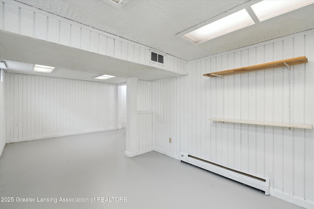 3427 W Jolly Rd, Lansing, MI 48911 - finished below grade area featuring a baseboard heating unit