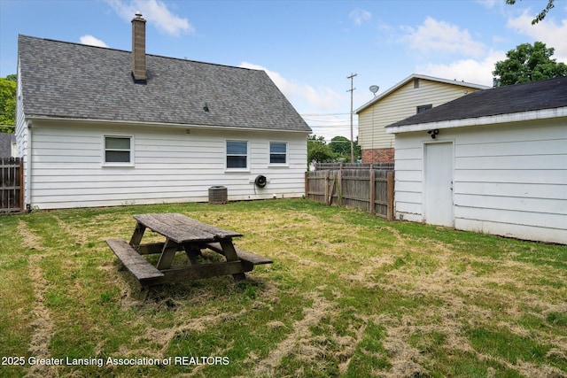 3427 W Jolly Rd, Lansing, MI 48911 - back of house with a chimney and roof with shingles