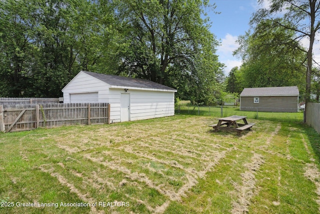 3427 W Jolly Rd, Lansing, MI 48911 - view of yard with a garage, an outdoor structure, and view of scattered trees