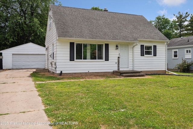 3427 W Jolly Rd, Lansing, MI 48911 - cape cod house with a detached garage, an outdoor structure, a shingled roof, and a front yard